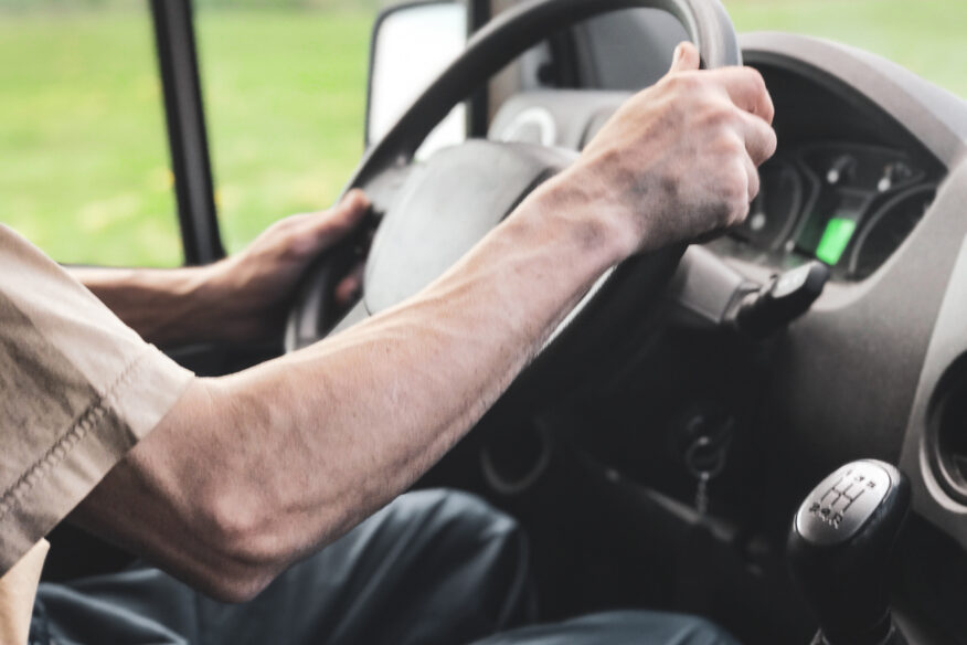 man driving steering wheel close up