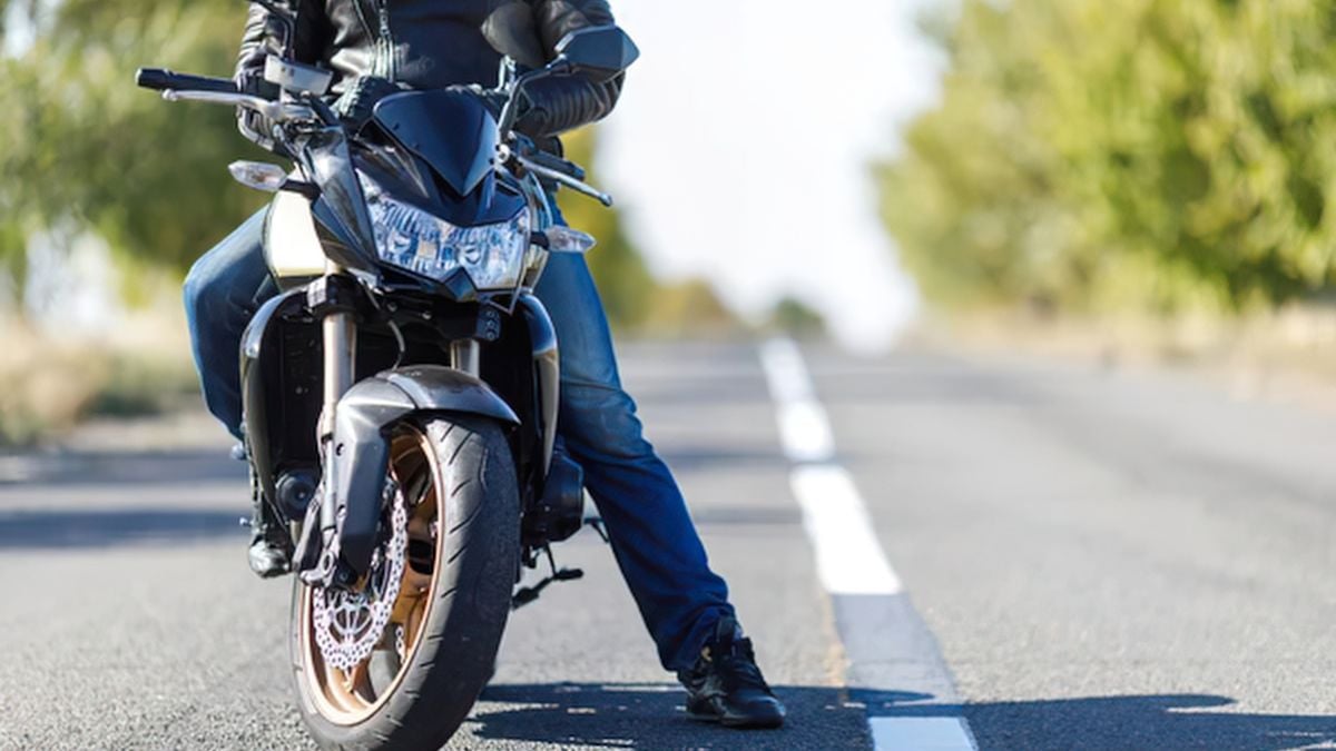 Motorbike rider on bike, stopped on the road